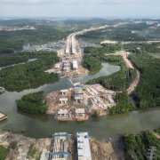 An unfinished road is blocked by water.